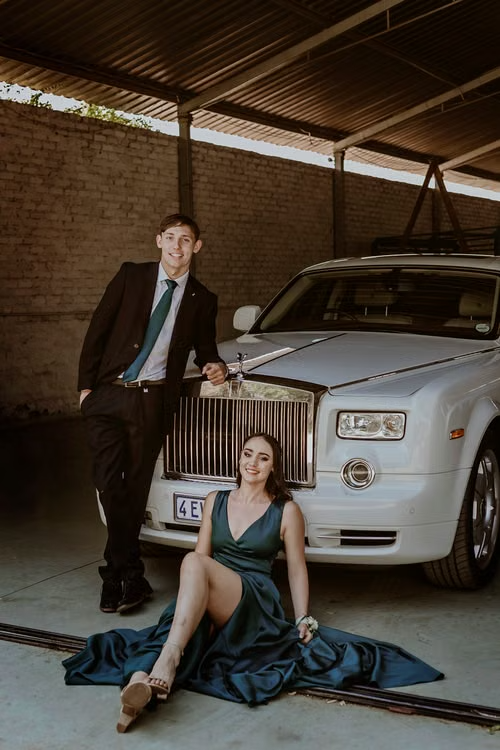 Couples standing in front of rental rolls royal after weeding